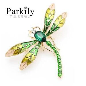 Brooch dragonfly in shades of green adorned with sparkly crystals